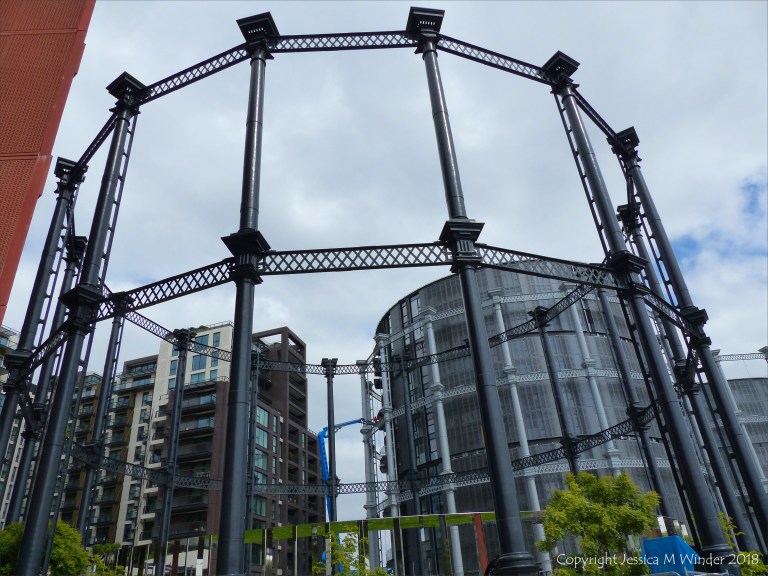 A circular mirrored garden in the structural framework of an old gasometer