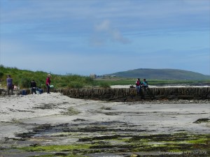 People picnicking on an old stone pier at Grit Ness