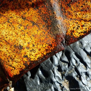 Rusty metal debris on the beach below the Spittles at Lyme Regis