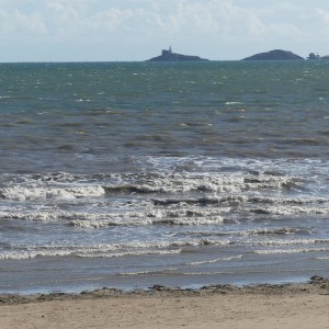Waves at Swansea Bay with Mumbles in background