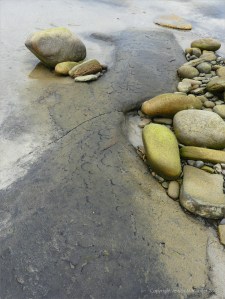 Peat beneath boulders on the beach
