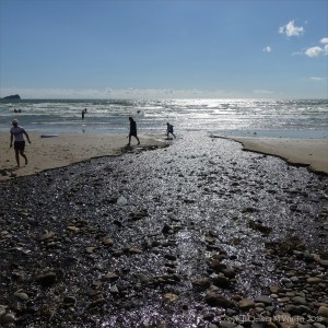 Looking downstream into the sun as Diles Lake flows into the sea