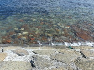 Underwater boulders by a sea wall