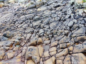 Cracked rock pavement on seashore