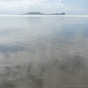 The sandy beach at low tide on Rhossili Bay