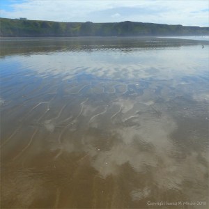The sandy beach at low tide on Rhossili Bay