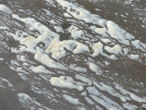 Natural patterns of sea foam on the beach