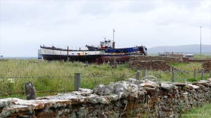 Stone walls and old boats near Stromness