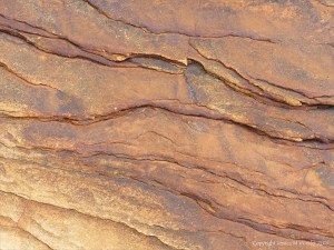 Water-worn sedimentary rock strata on the seashore