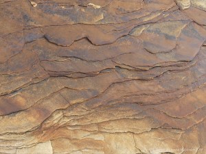 Water-worn sedimentary rock strata on the seashore