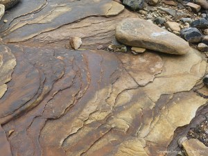 Water-worn sedimentary rock strata on the seashore