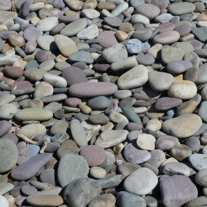 Pastel coloured dry pebbles on the beach