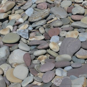 Pastel coloured dry pebbles on the beach