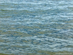 Natural patterns of reflected light on the surface of calm sea water