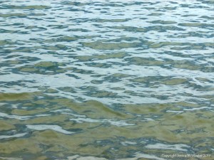 Natural patterns of reflected light on the surface of calm sea water