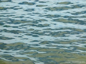 Natural patterns of reflected light on the surface of calm sea water