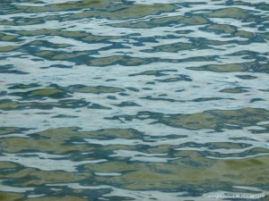 Natural patterns of reflected light on the surface of calm sea water