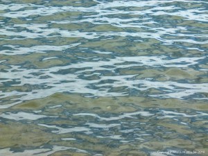 Natural patterns of reflected light on the surface of calm sea water