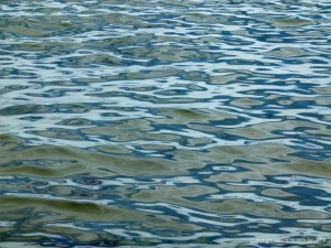 Natural patterns of reflected light on the surface of calm sea water