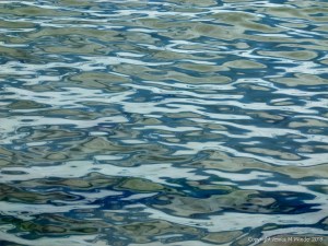 Natural patterns of reflected light on the surface of calm sea water