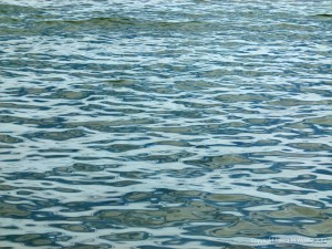 Natural patterns of reflected light on the surface of calm sea water