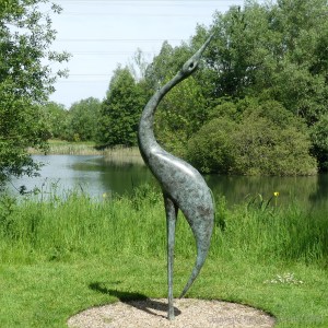"Geranos" bronze sculpture by a lake