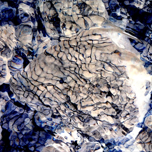 Part of a study of natural patterns of reflected light on river-bed pebbles