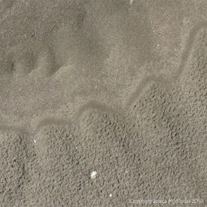 Natural sand patterns left by the ebbing tide