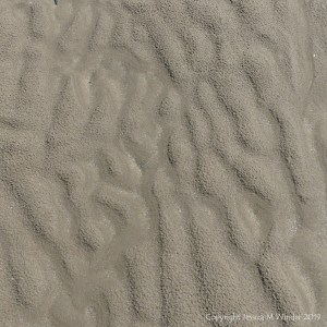 Natural sand patterns left by the ebbing tide