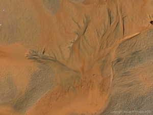 Orange mud on Rhossili beach