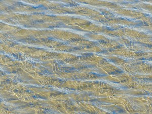Ripple patterns on shallow water over sand