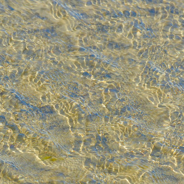Ripple patterns on shallow water over sand