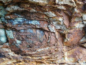 Rock colour, pattern and texture in spheroidal weathering: Rock pattern and texture caused by spheroidal weathering in cliffs at Smelt Sands State Park on the Oregon Coast in the U.S.A. as seen from Trail 804 and showing colours of decomposing iron minerals (12)
