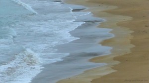 Waves gently breaking on a sandy beach