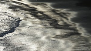 Beachscape with reflected dawn light on the sea