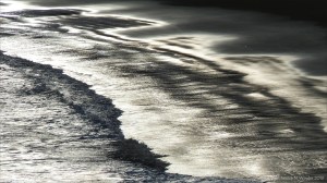 Beachscape with reflected dawn light on the sea