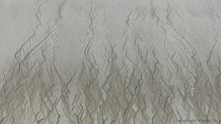 Natural patterns in the sand on a beach as the tide goes out