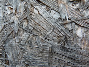 Close-up photograph showing texture in weathered chipboard