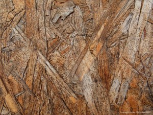 Close-up photograph showing texture in weathered chipboard