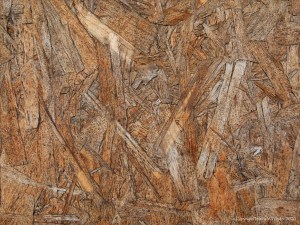 Close-up photograph showing texture in weathered chipboard