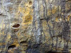 Graffiti carved into natural rock face