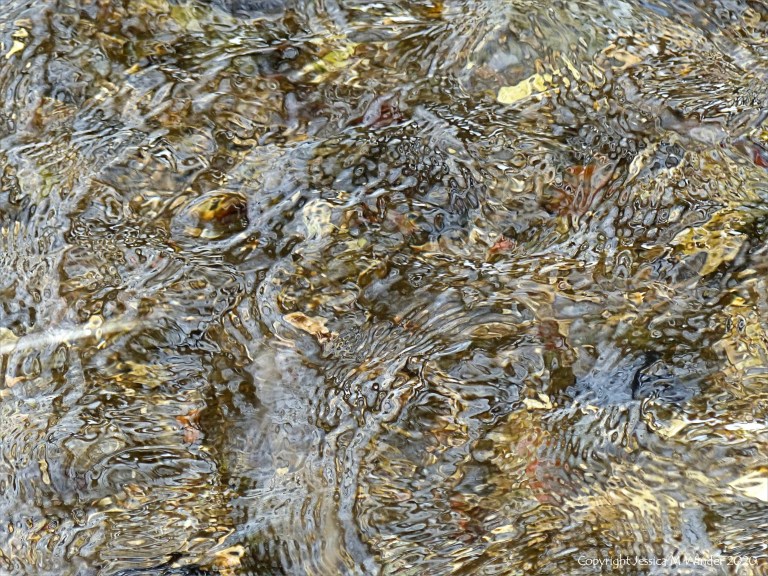 Close-up of pattern and texture in a fast flowing shallow river