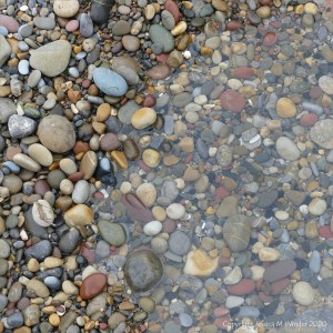 Smooth coloured pebbles at Caswell Bay