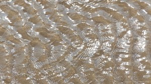 Rippled water of a beach stream at Swansea Bay