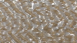 Rippled water of a beach stream at Swansea Bay