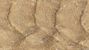 Rippled water of a beach stream at Swansea Bay