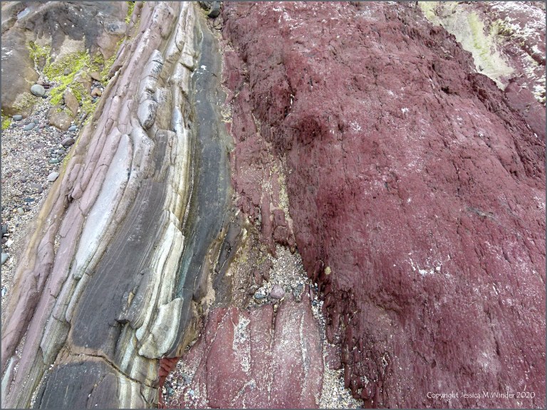 Red and grey rocks on the seashore