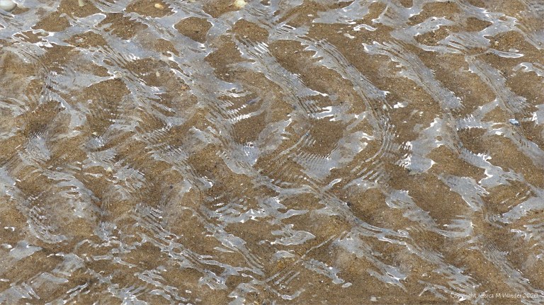 Patterns of reflected light on the surface of rippled water