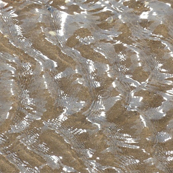 Patterns of reflected light on the surface of rippled water