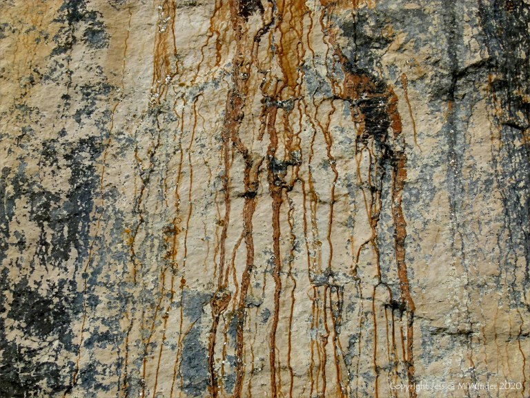 Iron-stained patterns on limestone rocks